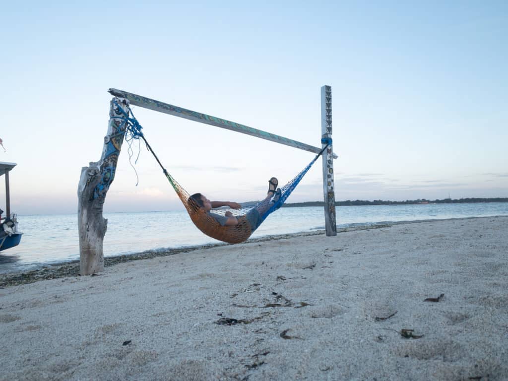 Hanging on a hammock on the beach at sunrise in Gili Air