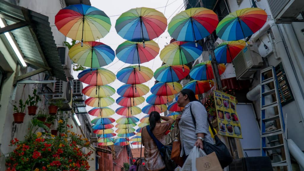 Tourist admire Umbrella Alley in Penang Art Installation unknown artist