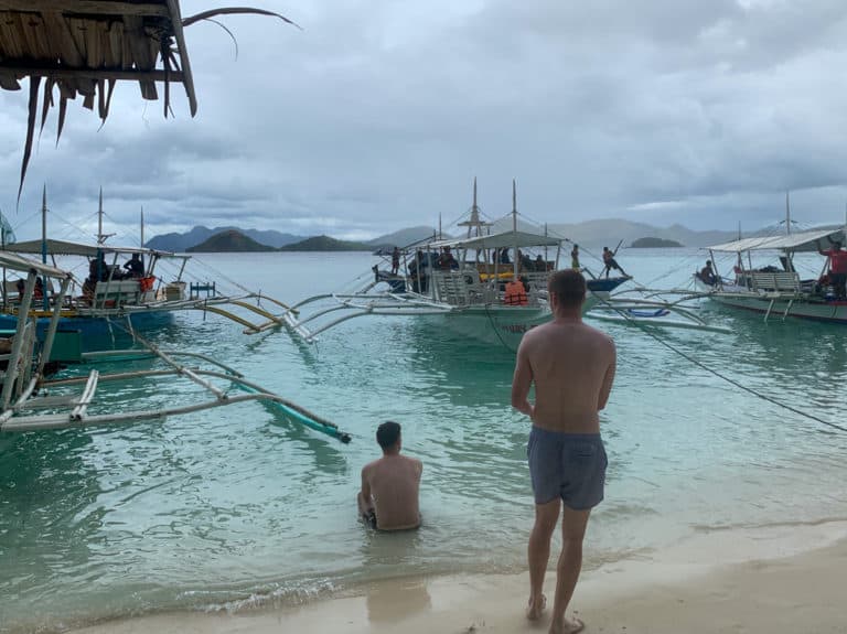 Friends hanging out on beach in Coron Philippines