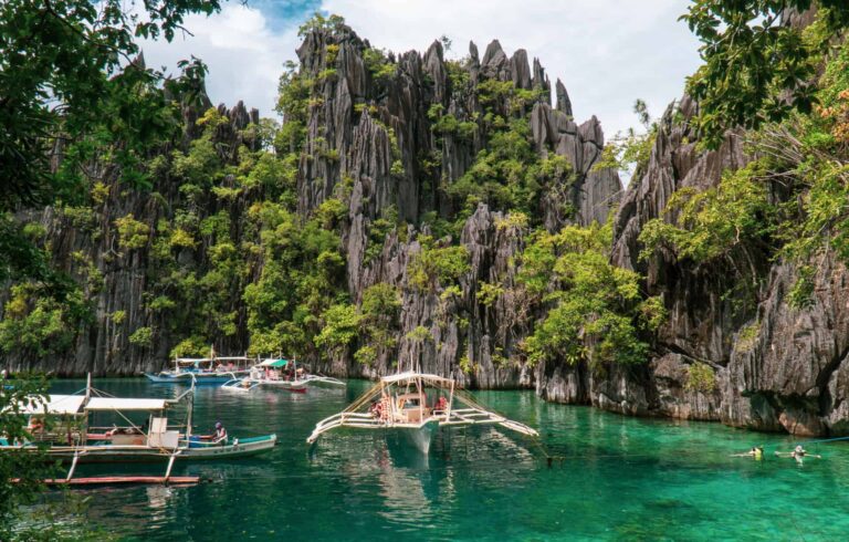 Clear water at Twin Lagoon with bangka boats  anchored in Coron, Palawan,Philippines