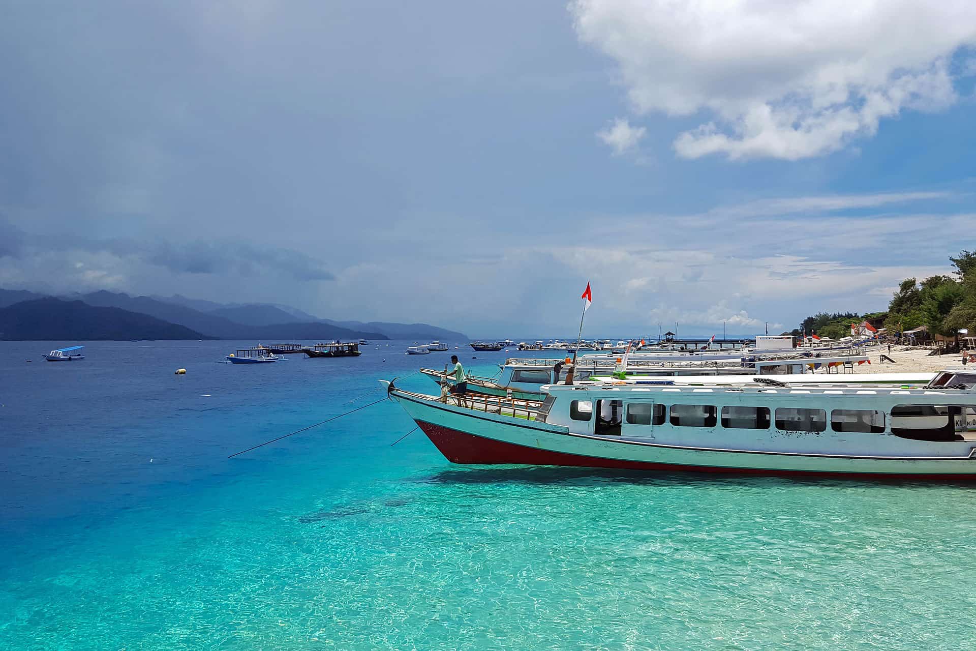 Profile view of a ferry boat in Gili Island with clear aqua blue ocean water in Indonesia