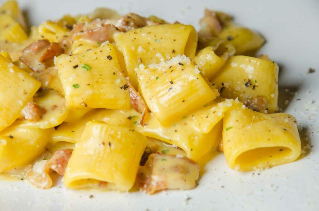 Rigatoni Carbonara is a famous Rome pasta dish with prosciutto and an egg based creamy sauce